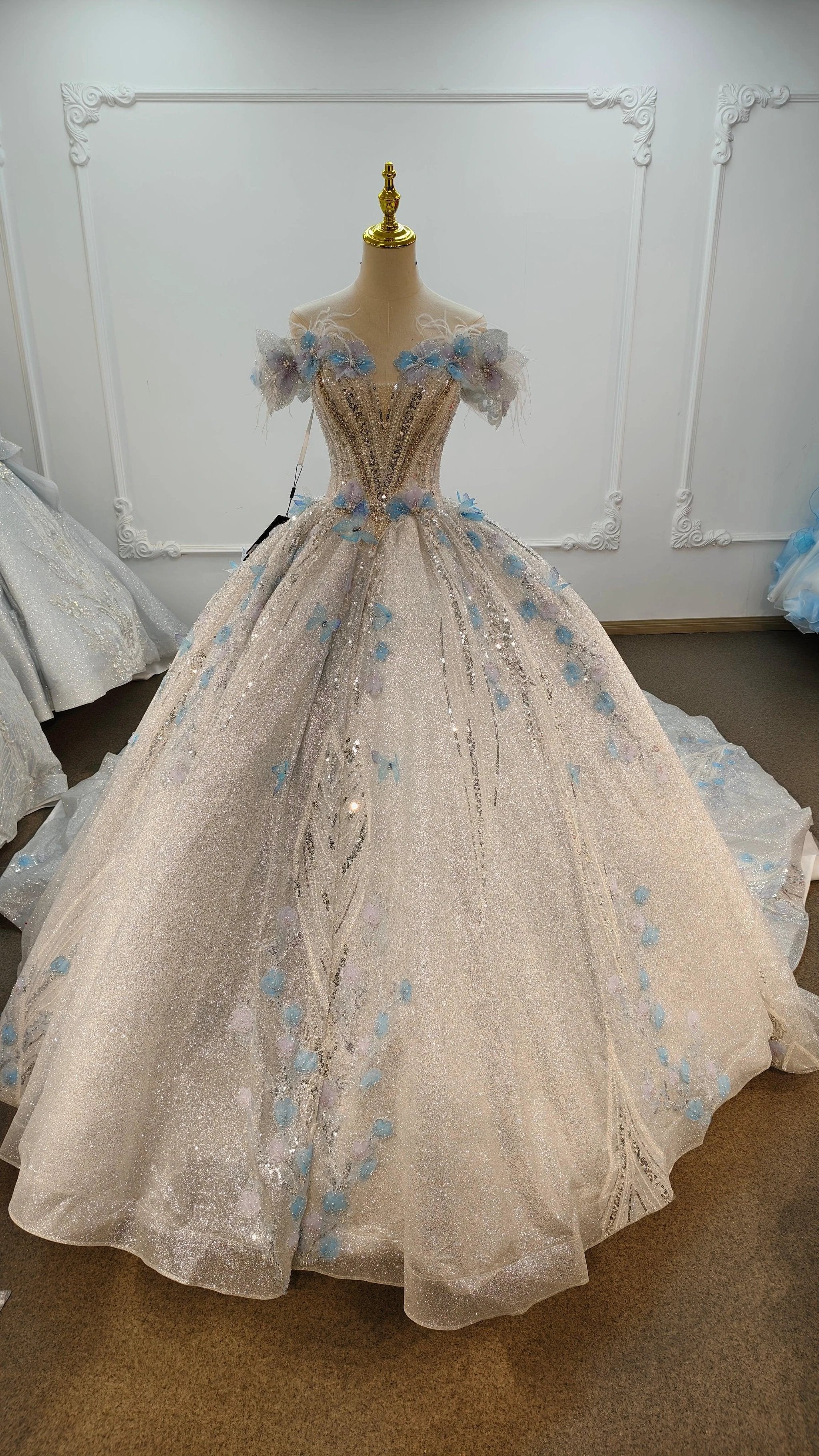 Ethereal Off-the-Shoulder Ball Gown Wedding Dress with Sequin Tulle, 3D Pastel Florals & Feather Accents Ye-2028
