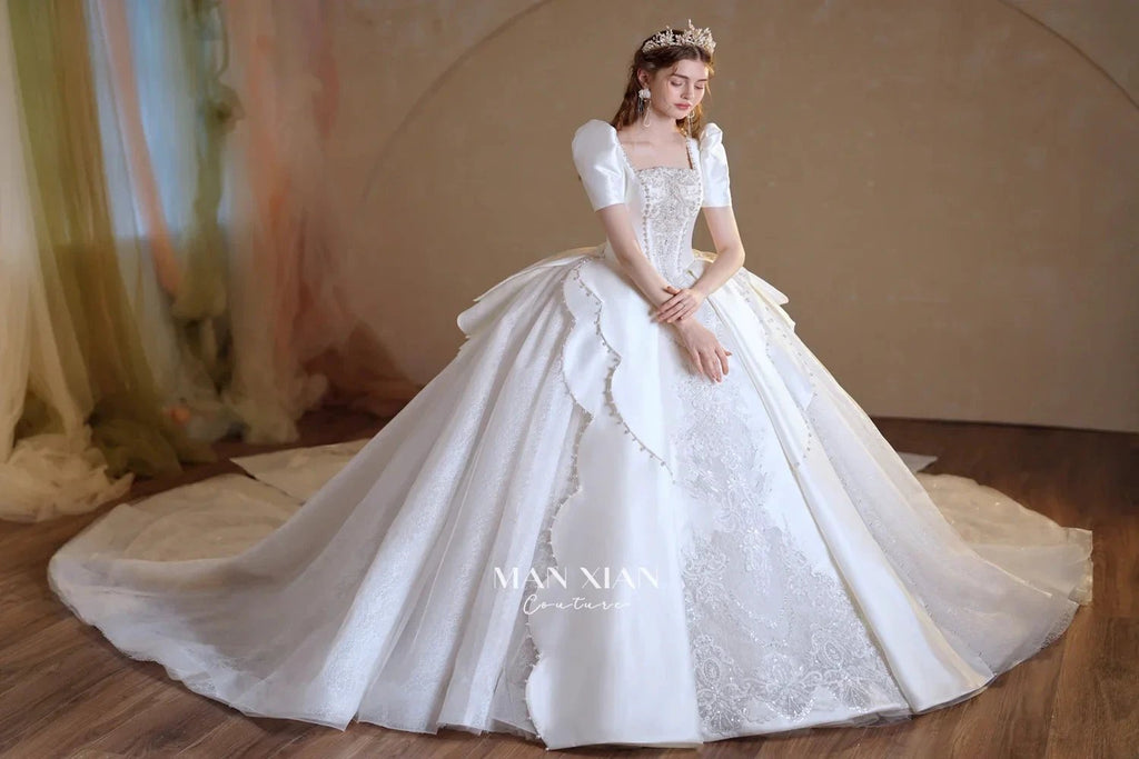 Regal Ivory Square-Neck Satin Ball Gown with Puff Sleeves, Pearl Embroidery & Oversized Bow Train m011
