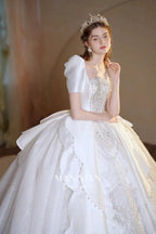 Regal Ivory Square-Neck Satin Ball Gown with Puff Sleeves, Pearl Embroidery & Oversized Bow Train m011